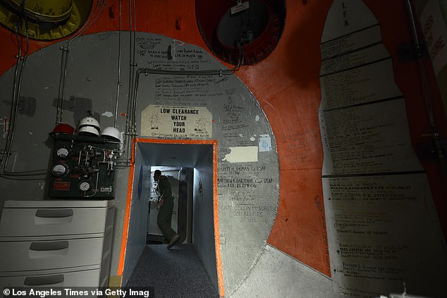 Above, a missile combat crew member at Salas' old post, Malmstrom Air Force Base, prepares to close a three-foot thick door inside a nuclear launch control center 70-feet underground