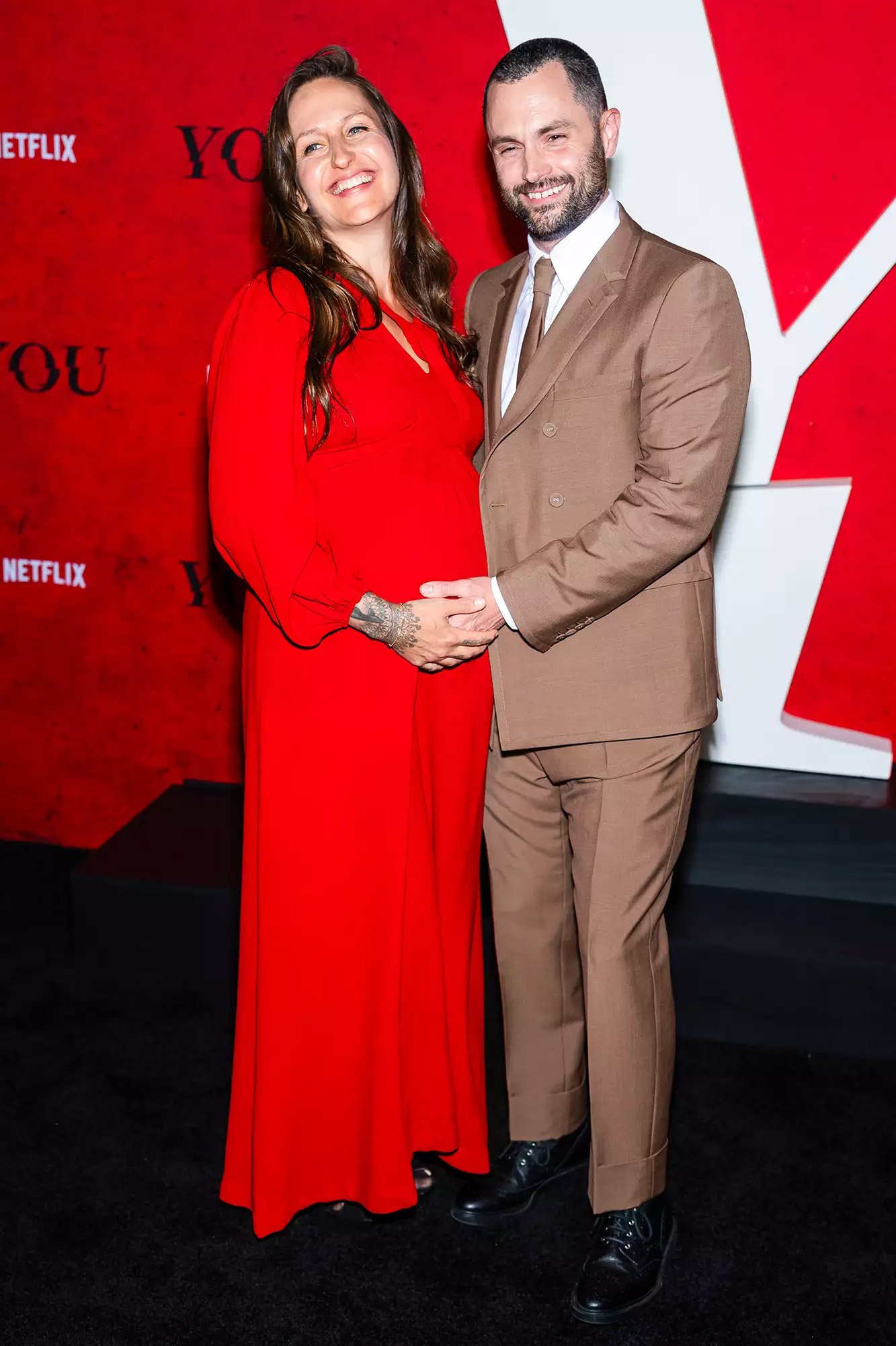 Penn Badgley’s pregnant wife debuts her baby bump at You red carpet