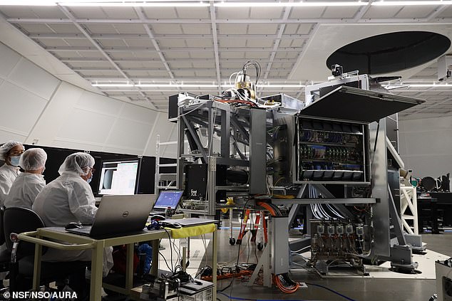 Engineers and scientists work on the Visible Tunable Filter (VTF) inside the Coudé Lab at the Inouye Solar Telescope, preparing the instrument for its first light
