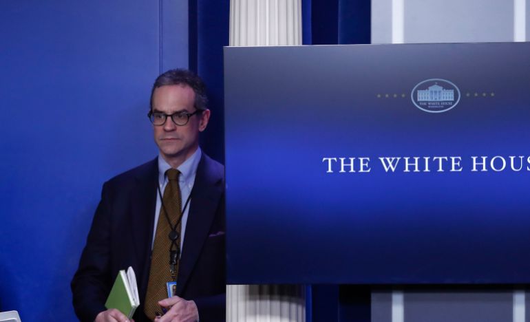 Michael anton near a screen that reads "The White House"