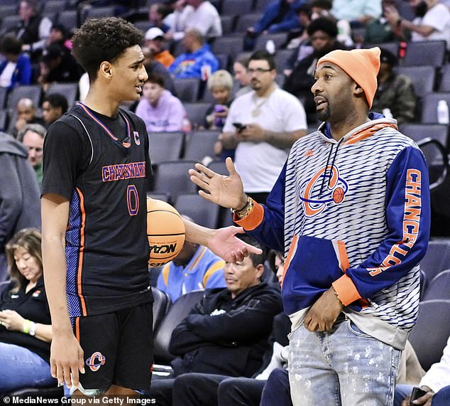 Arenas, 43, is seen talking to his son during halftime of a basketball game in March 2024