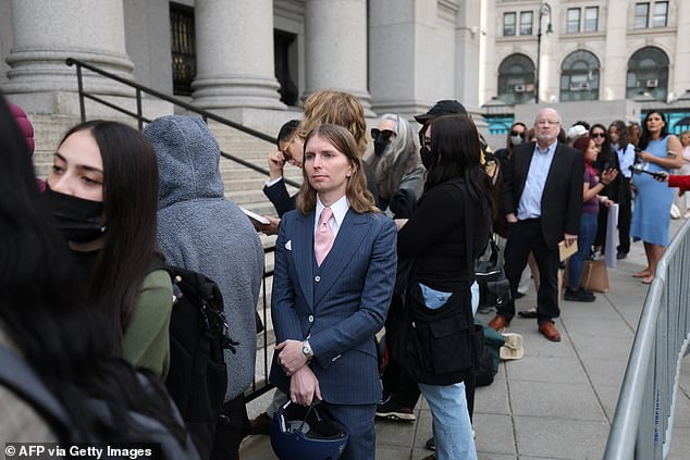 Chelsea Manning wore a gray suit and pink tie when she joined the line for Mangione's hearing on Friday