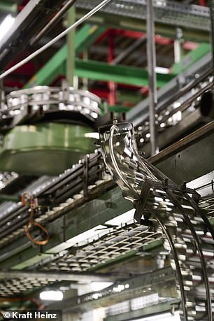 Steel cans are moved through the factory at high speed