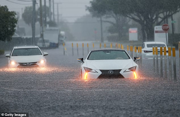 Pictured, vehicles sit in a flooded street on June 12, 2024 in Aventura, Florida. The region was adversely impacted as tropical moisture passes through the area