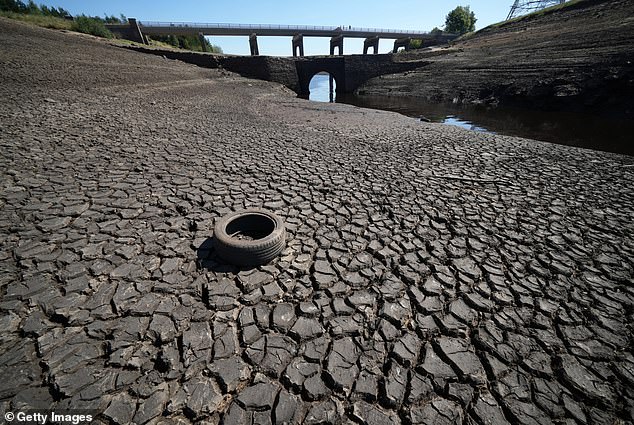 Low water levels at Baitings Reservoir, Ripponden, England reveal an ancient pack horse bridge as drought conditions continue in the UK heatwave in the summer of 2022