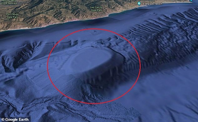 The natural underwater structure looks like a bump pushing up from the ocean floor , with a flat, table-like top
