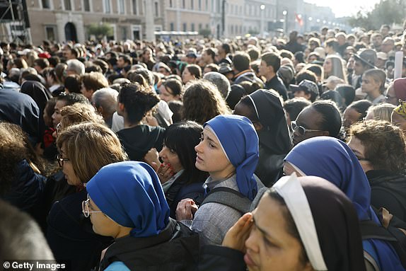 VATICAN CITY, VATICAN - APRIL 26: Members of the faithful gather during the funeral of Pope Francis in St. Peter's Square on April 26, 2025 in Vatican City, Vatican. Pope Francis died on April 21st at the age of 88. Born in Argentina as Jorge Mario Bergoglio, he was the first Latin American and the first Jesuit to become Pope when elected in 2013. Taking the name Francis after St Francis of Assisi, he promoted a more humble version of the papacy than many of his predecessors. He will be buried outside of the Vatican in a simple wooden coffin at the Basilica Santa Maria Maggiore.  (Photo by Mario Tama/Getty Images)