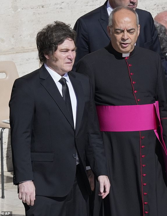 Argentina's President Javier Milei, left, arrives for the funeral of Pope Francis in St. Peter's Square at the Vatican, Saturday, April 26, 2025. (AP Photo/Gregorio Borgia)