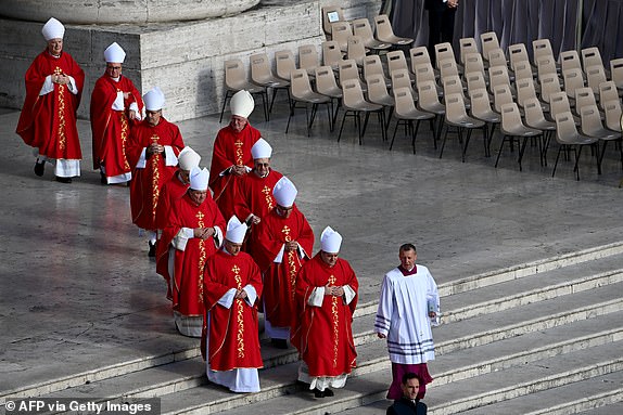 Cardinals come down the stairs of St Peter's Basilica as they arrive for the late Pope Francis' funeral ceremony at St Peter's Square in The Vatican on April 26, 2025. (Photo by Isabella BONOTTO / AFP) (Photo by ISABELLA BONOTTO/AFP via Getty Images)