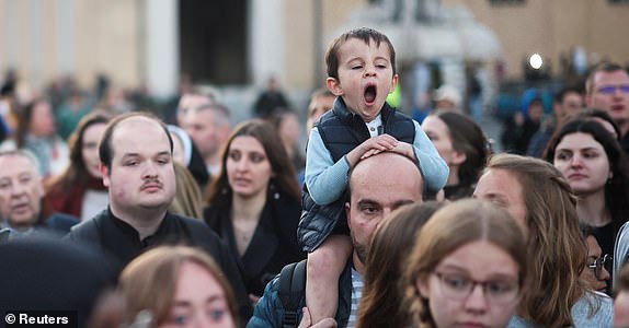 People gather, ahead of the funeral Mass of Pope Francis at St. Peter's Square, as seen from Rome, Italy, April 26, 2025. REUTERS/Hannah McKay