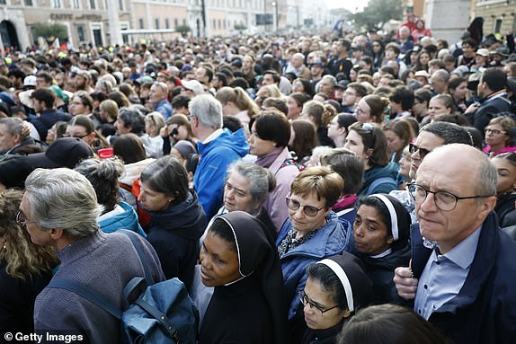 VATICAN CITY, VATICAN - APRIL 26: Members of the faithful gather during the funeral of Pope Francis in St. Peter's Square on April 26, 2025 in Vatican City, Vatican. Pope Francis died on April 21st at the age of 88. Born in Argentina as Jorge Mario Bergoglio, he was the first Latin American and the first Jesuit to become Pope when elected in 2013. Taking the name Francis after St Francis of Assisi, he promoted a more humble version of the papacy than many of his predecessors. He will be buried outside of the Vatican in a simple wooden coffin at the Basilica Santa Maria Maggiore.  (Photo by Mario Tama/Getty Images)