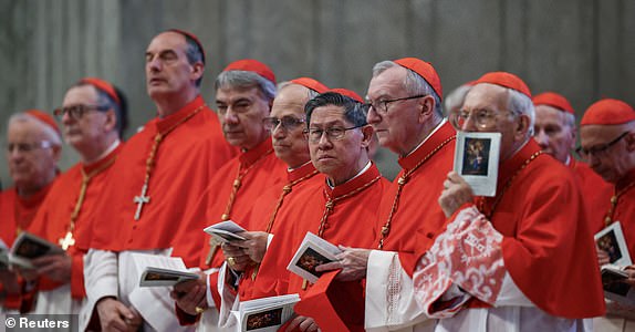 Cardinal Luis Antonio Tagle, Cardinal Pietro Parolin and other Cardinals stand, on the day of the translation of Pope Francis' body, in St. Peter's Basilica at the Vatican, April 23, 2025. REUTERS/Yara Nardi               SEARCH "POPE FRANCIS PORTRAITS" FOR THIS STORY. SEARCH "WIDER IMAGE" FOR ALL STORIES.