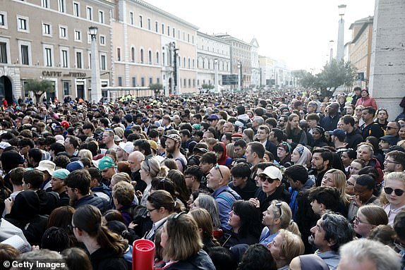 VATICAN CITY, VATICAN - APRIL 26: Members of the faithful gather during the funeral of Pope Francis in St. Peter's Square on April 26, 2025 in Vatican City, Vatican. Pope Francis died on April 21st at the age of 88. Born in Argentina as Jorge Mario Bergoglio, he was the first Latin American and the first Jesuit to become Pope when elected in 2013. Taking the name Francis after St Francis of Assisi, he promoted a more humble version of the papacy than many of his predecessors. He will be buried outside of the Vatican in a simple wooden coffin at the Basilica Santa Maria Maggiore.  (Photo by Mario Tama/Getty Images)