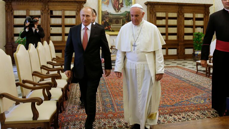 Pope Francis walks next to Putin at the Vatican in 2015. Pic: AP