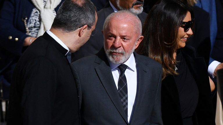 Brazil's president looks on next to his wife Rosangela. Pic: Reuters