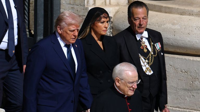 U.S President Donald Trump and first lady Melania Trump walk to attend the funeral Mass of Pope Francis, at the Vatican, April 26, 2025. REUTERS/Kai Pfaffenbach