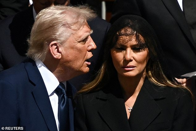 The First Lady wore a solemn expression today and remained by Trump's side, with her attendance at the funeral expected to be crucial to keeping the peace between him and his predecessor Joe Biden