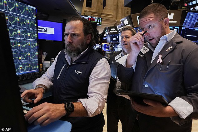 Specialist Michel Pistillo, left, works with traders James Matthews, centre, and Ryan Falvey on the floor of the New York Stock Exchange on Wednesday