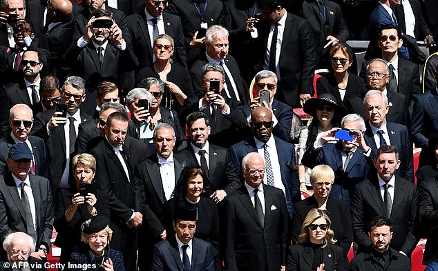 The photographs were taken as pall bearers were transporting Pope Francis' coffin inside the Basilica at the end of the service