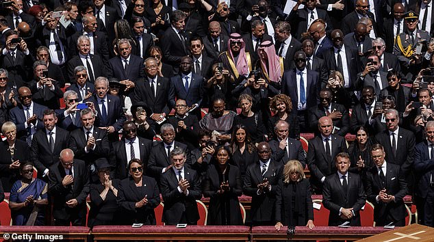 Some guests were seen blatantly taking photos rather than joining in with the solemnity of the moment