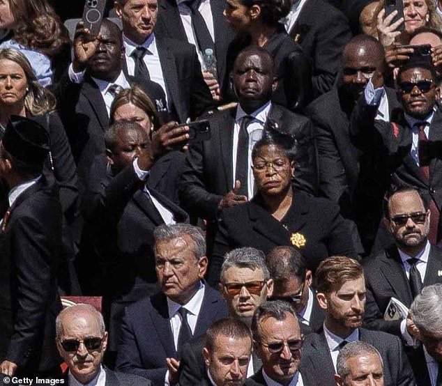 Tayebwa taking a snap as Pope Francis's coffin inside the Basilica from the crowd
