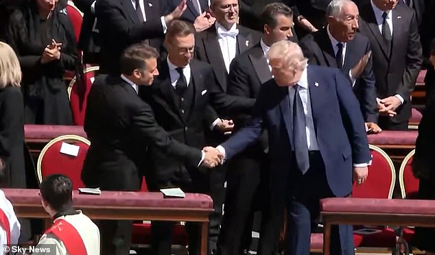 Trump (right) and Macron (left) shake hands at the funeral Mass