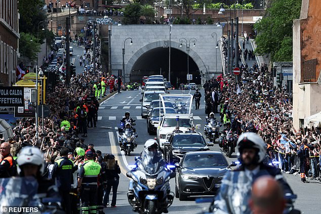 Thousands of people line the streets as the coffin is transferred to the Papal Basilica