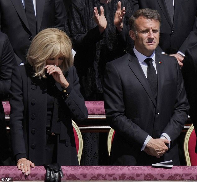 Emmanuel Macron and his wife react during the ceremony