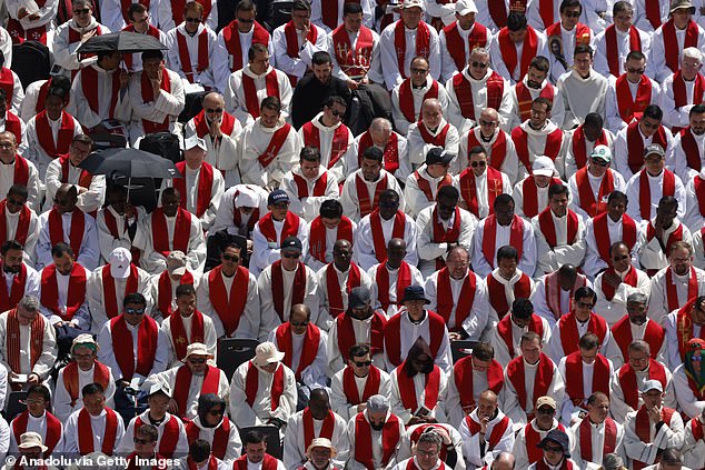 Italian cardinal Giovanni Battista Re (L) officiates near the coffin in St Peter's Square