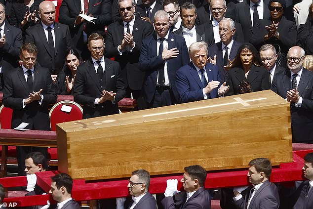 Trump was sat in the front row alongside (L-R) French President Emmanuel Macron, Finnish President Alexander Stubb and First Lady Melania Trump