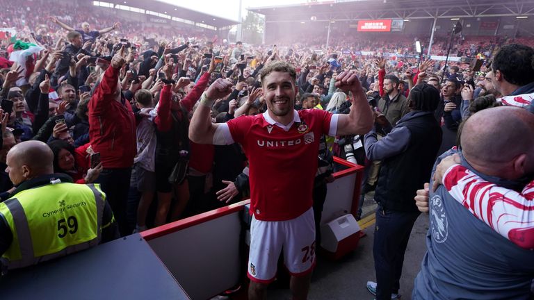 Wrexham's Sam Smith celebrates in front of the fans on the pitch after Wrexham won promotion to the Sky Bet Championship after the Sky Bet League One match at SToK Racecourse, Wrexham. Picture date: Saturday April 26, 2025. PA Photo. See PA story SOCCER Wrexham. Photo credit should read: Martin Rickett/PA Wire...RESTRICTIONS: EDITORIAL USE ONLY No use with unauthorised audio, video, data, fixture lists, club/league logos or "live" services. Online in-match use limited to 120 images, no video emulation. No use in betting, games or single club/league/player publications.