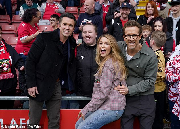 McElhenney, Lively and Reynolds greet a Wrexham fan ahead of the promotion winning match