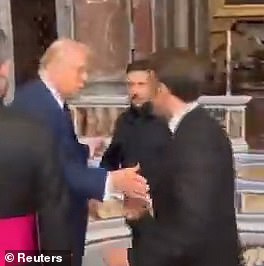 It appears Macron attempted to grab Trump's hand, but overshot, as his hand was send cupped under Trump's arm