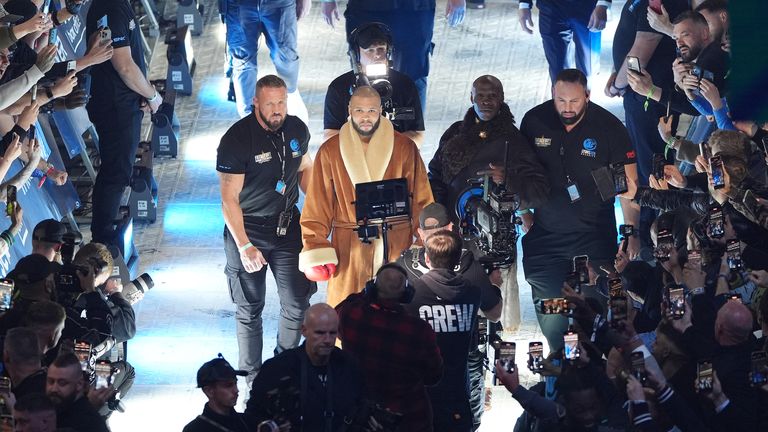 Chris Eubank Jr and Chris Eubank Sr walk together to the ring. Pic: PA