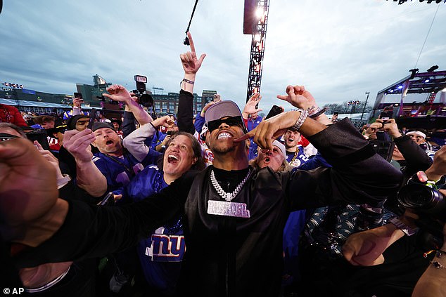 Carter celebrates with fans after being chosen by the New York Giants with the third pick