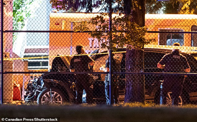 Vancouver Police look over a black car involved in the incident at the Lapu Lapu Festival