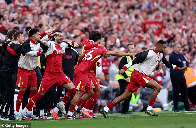 Reds players sprint on to the pitch at the full-time whistle confirms their status as champions