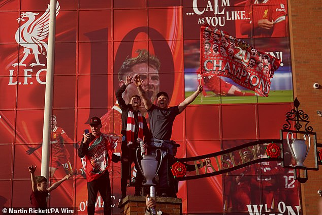 Liverpool fans celebrate outside of Anfield following their historic triumph on Sunday