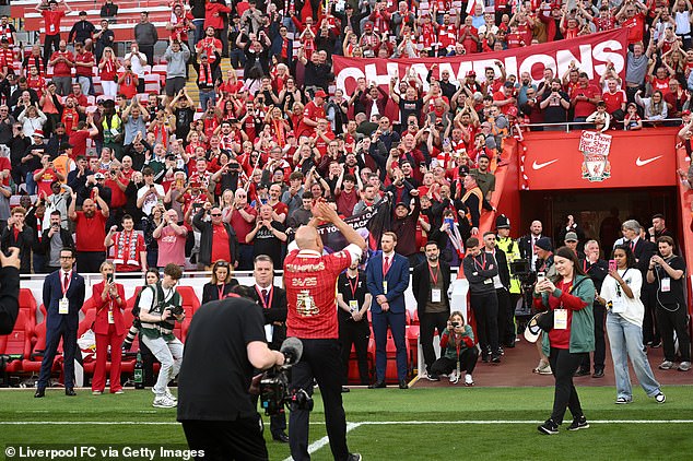 Slot acknowledges the fans as they serenade their manager after leading them to a 20th title