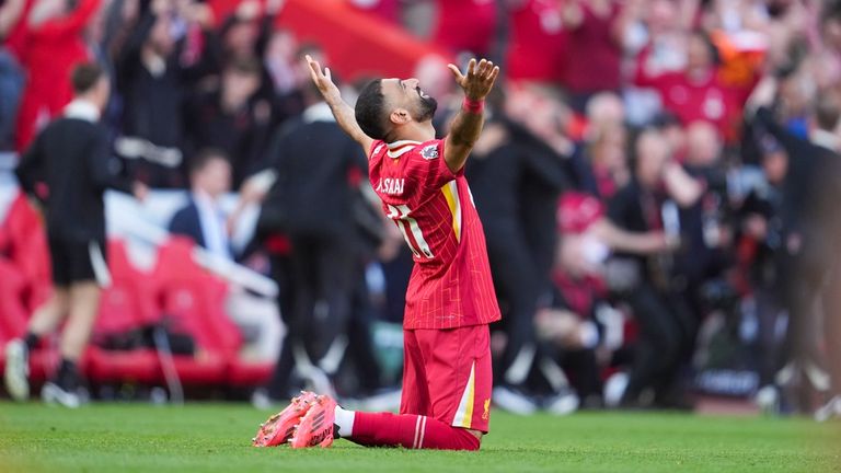 Salah on his knees in celebration after the final whistle. Pic: AP