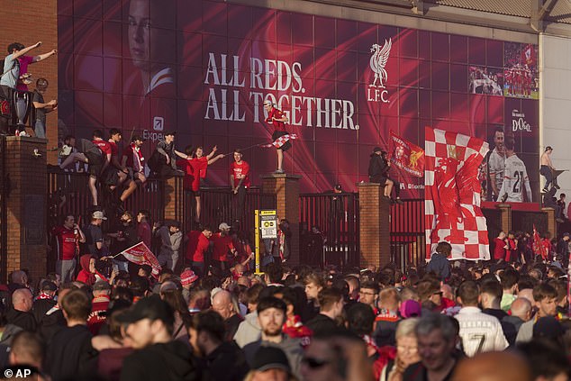 Supporters climbed on top of the railings outside the Kop to toast their team's success
