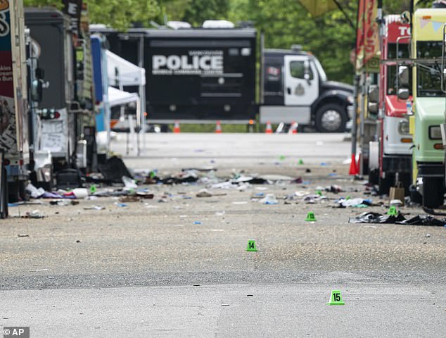 Evidence markers line 43rd Avenue in Vancouver, where a vehicle drove into crowd at a street festival on the night before