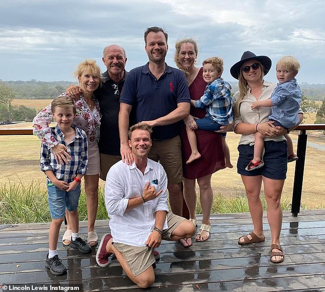 Lewis, pictured in happier times with his children and grandchildren, has denied there is a family feud because of his new relationship