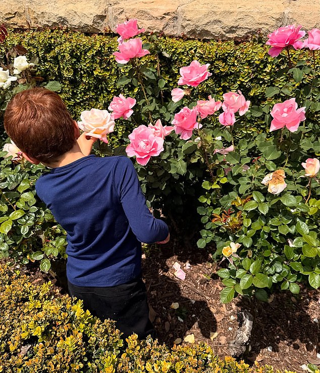 Prince Archie wore a navy blue, long-sleeved shirt to pick flowers with his mother and sister