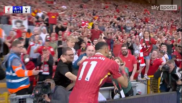 The Egyptian was handed the device by a women decked in club gear on the side of the pitch