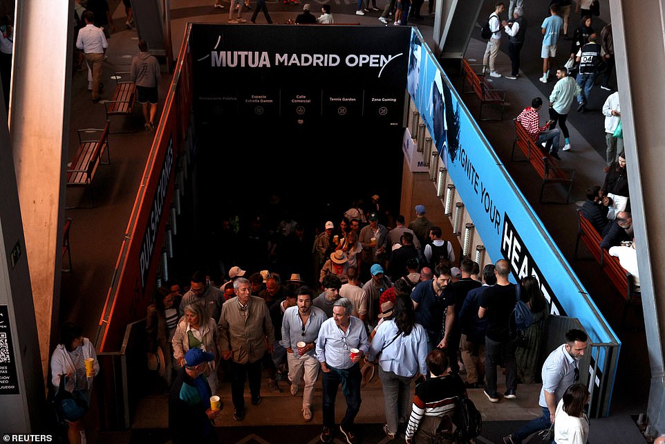 Tennis fans are seen after matches were suspended at the Madrid Open due to a power outage