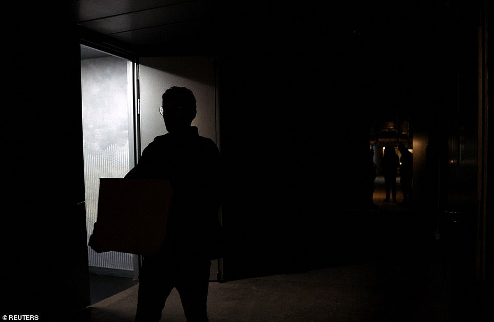 A person is seen in a dark corridor after matches are suspended at Madrid Open due to a power outage