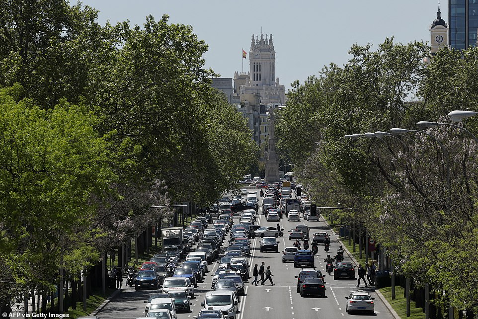 Police car officers (C) is parked under switched-off traffic lights during a massive power cut affecting the entire Iberian peninsula and the south of France, in Madrid