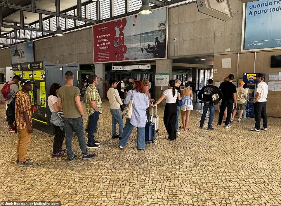People queue for the ATM at downtown Lisbon during a massive power cut