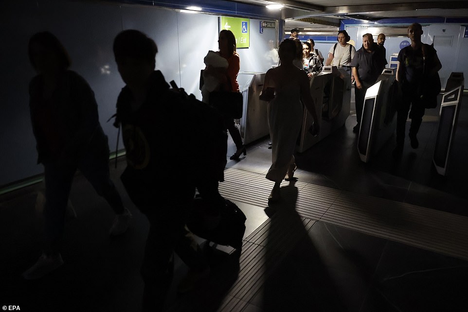 Commuters leave a subway station after a blackout hit Spain and Portugal, in Madrid